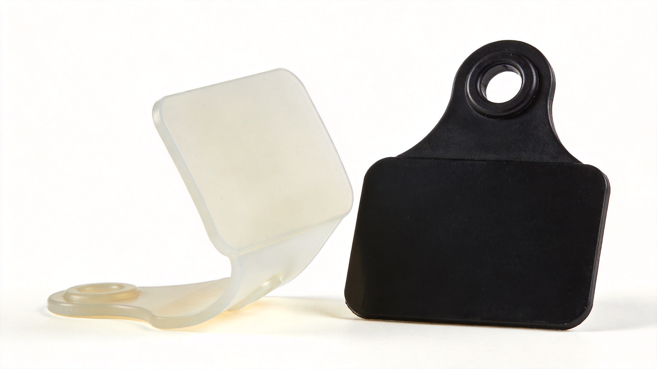 TPU vs ABS blank cattle ear tag material comparison showing flexibility difference