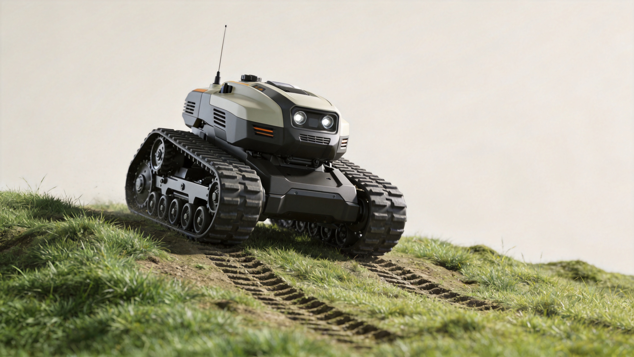 Tracked lawn mower crossing firm uneven grass on rough land