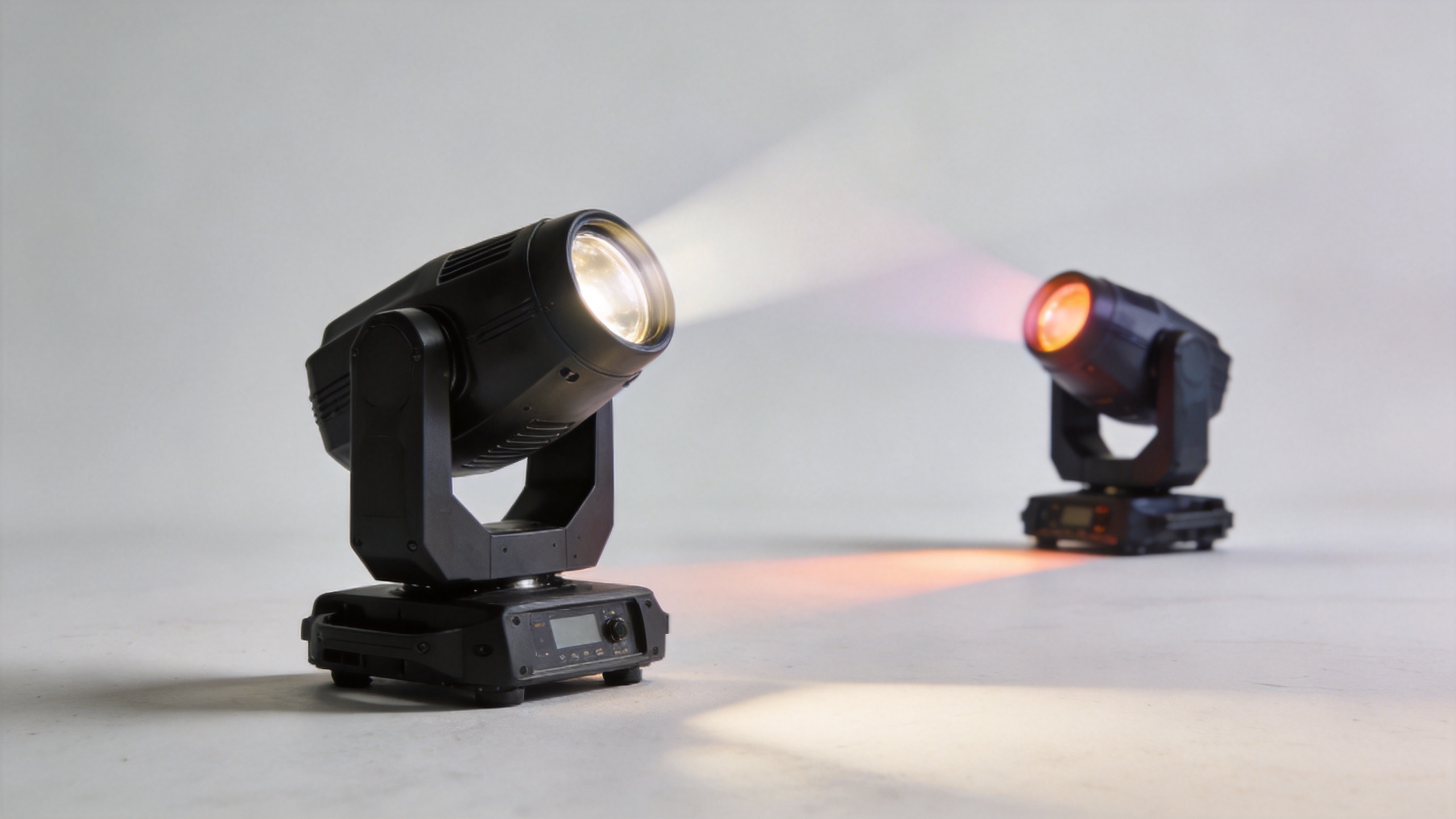 Moving head fixtures creating beams, colors, and gobo patterns in a live event venue