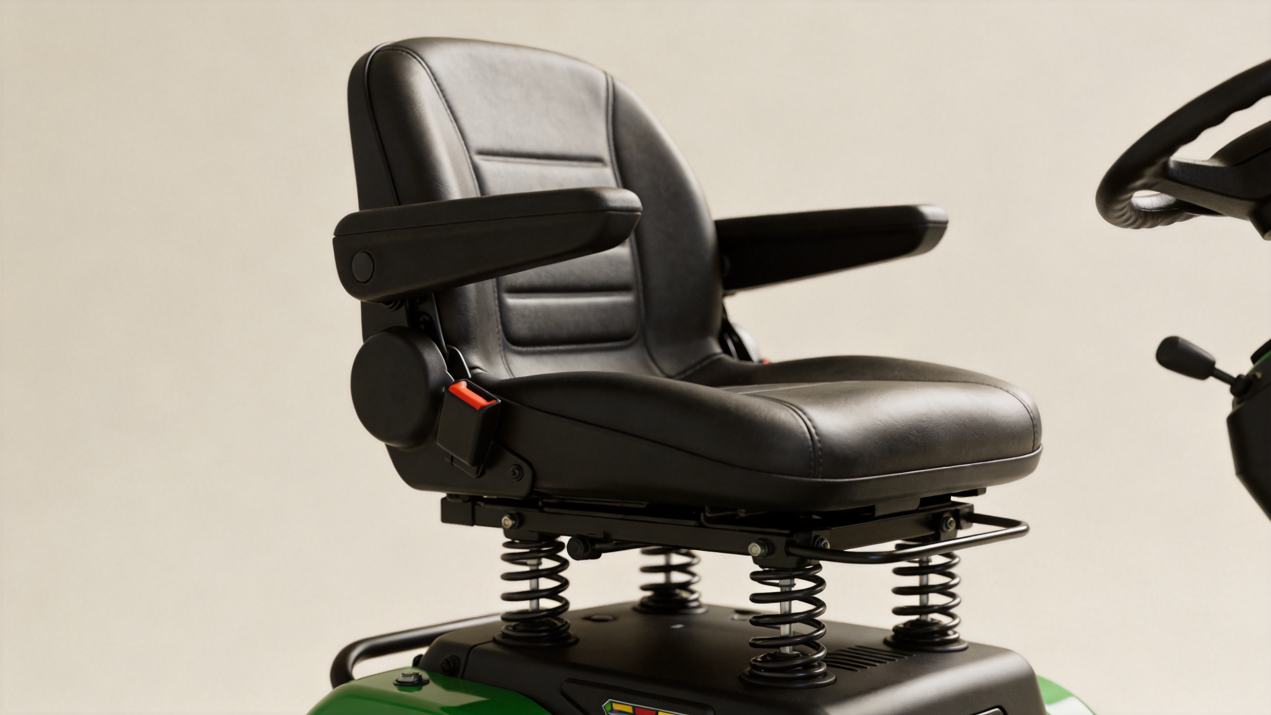Ride on mower ergonomic seat with spring suspension mechanism showing operator comfort design