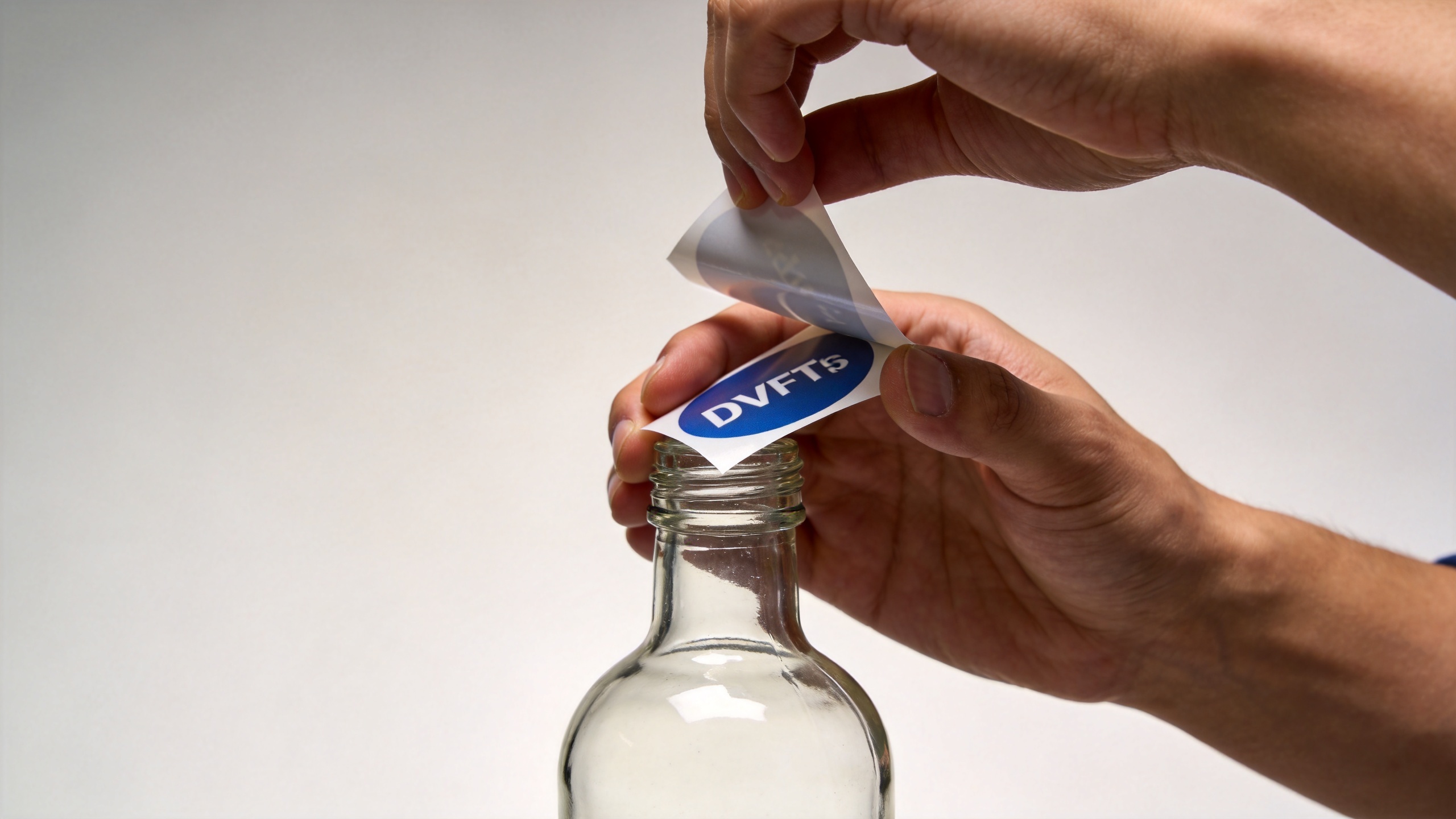 Applying a UV DTF sticker to a smooth glass hard surface