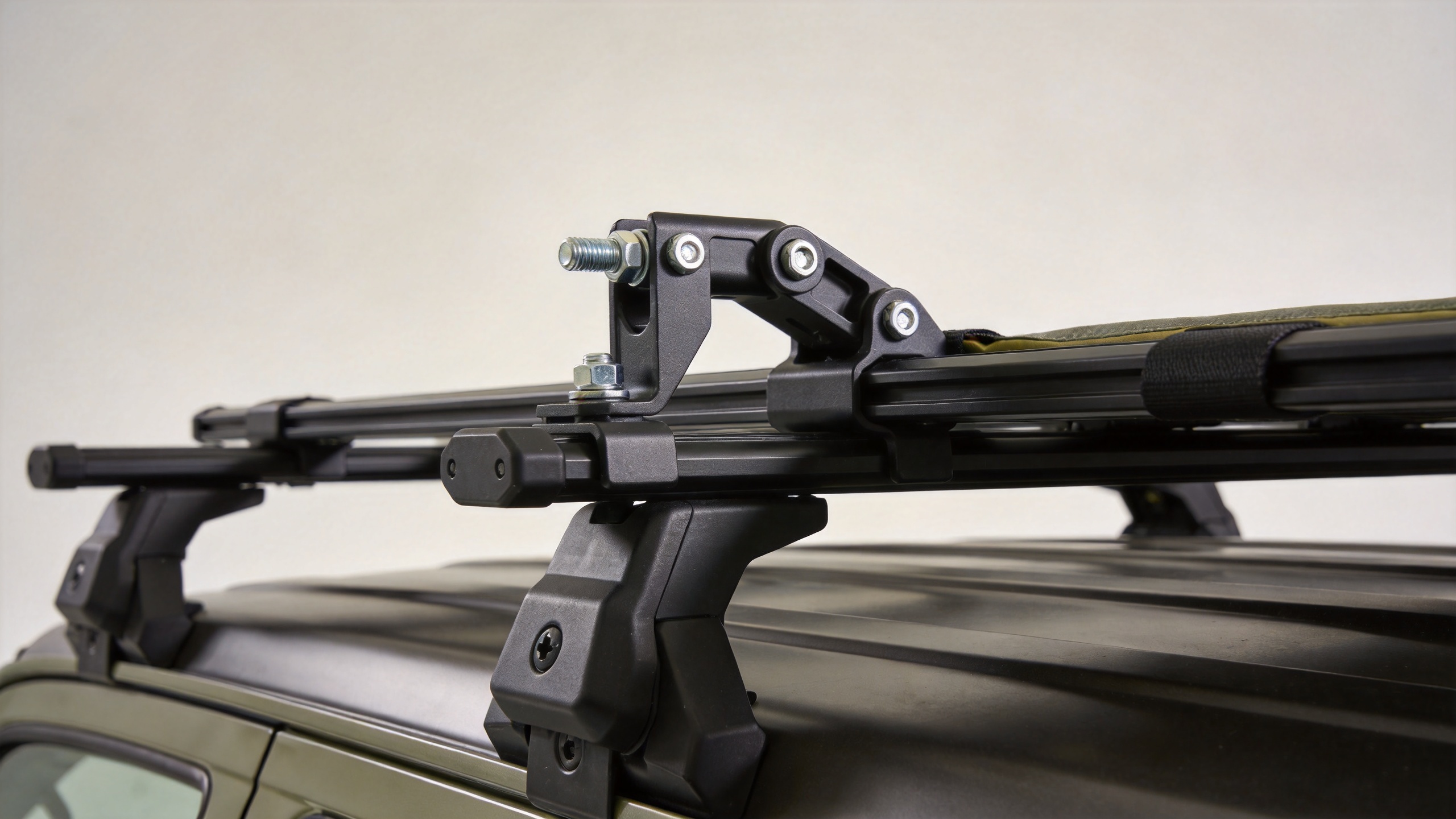 Roof top tent mounting brackets attached to crossbars on a vehicle roof rack