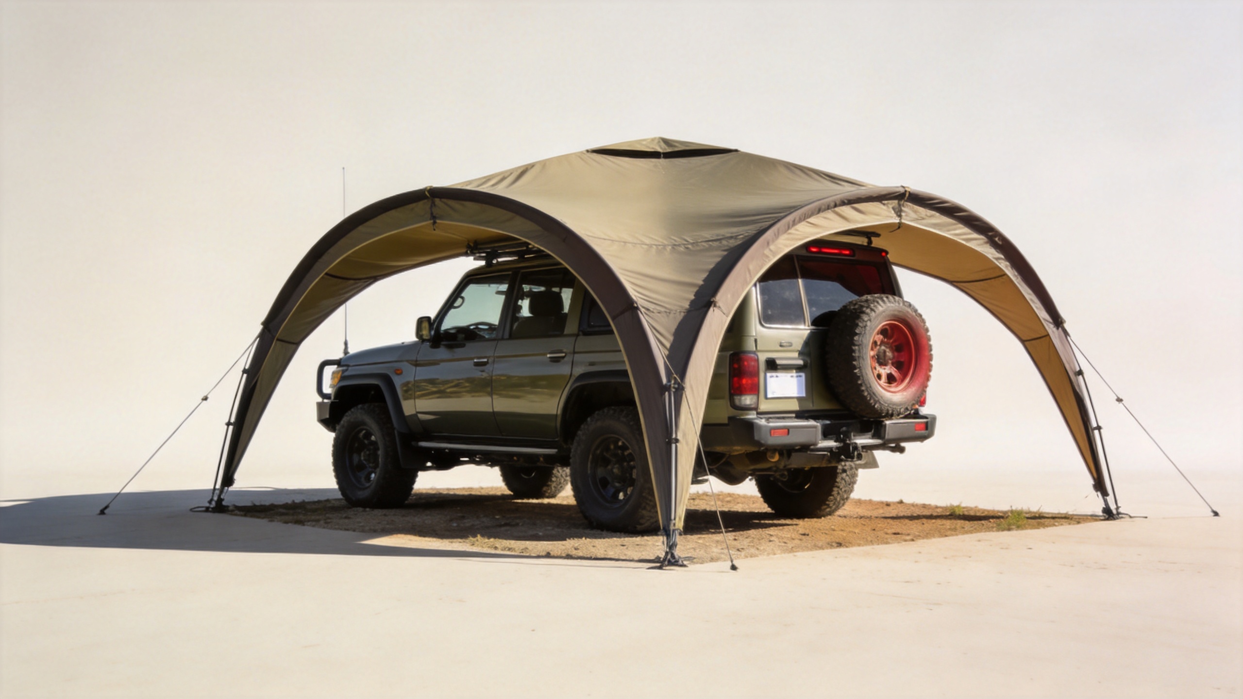 270 degree awning deployed around a 4WD vehicle at a campsite showing wide wraparound shade coverage