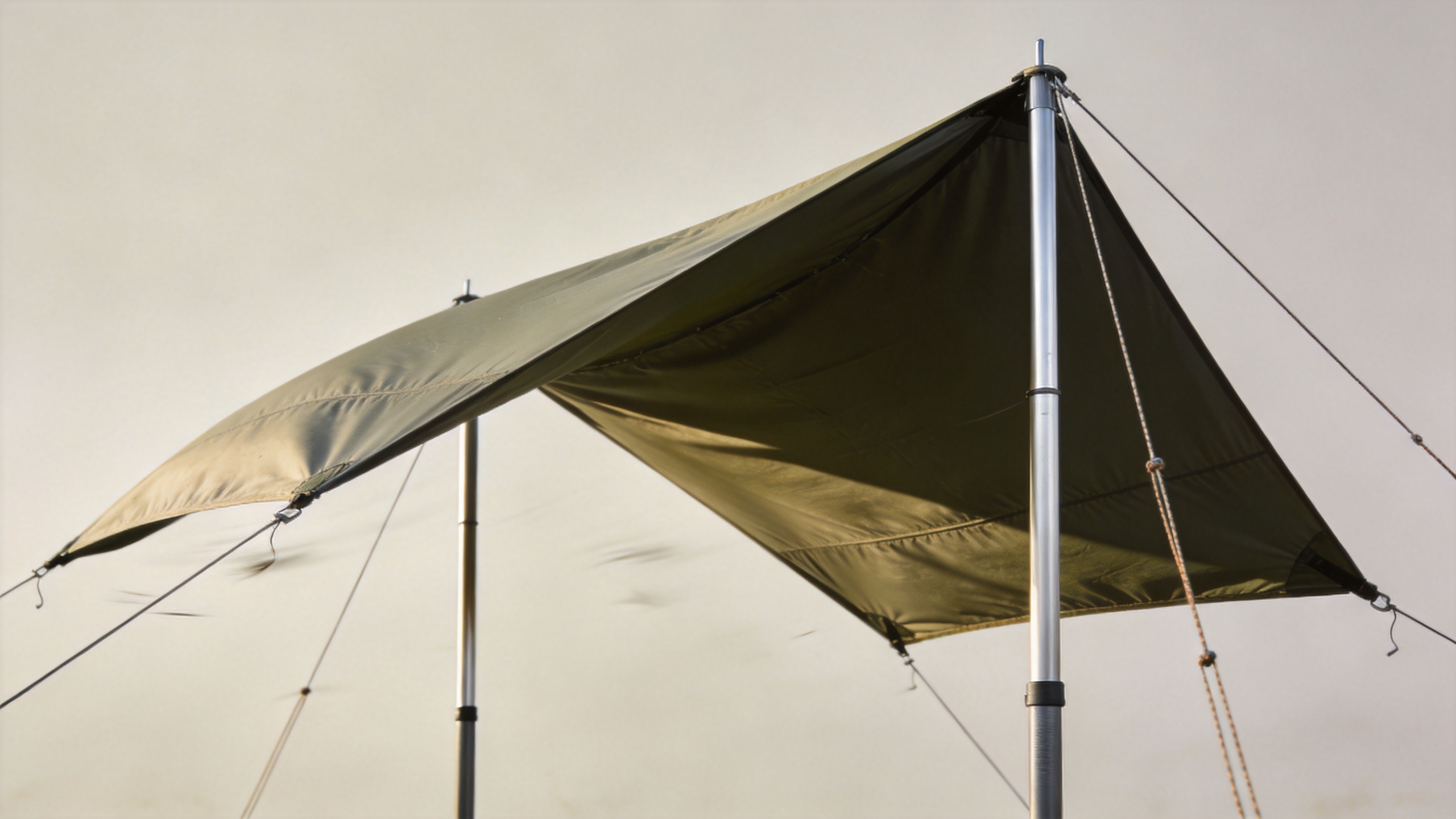 free standing awning deployed in windy outdoor conditions with guy wires and staking