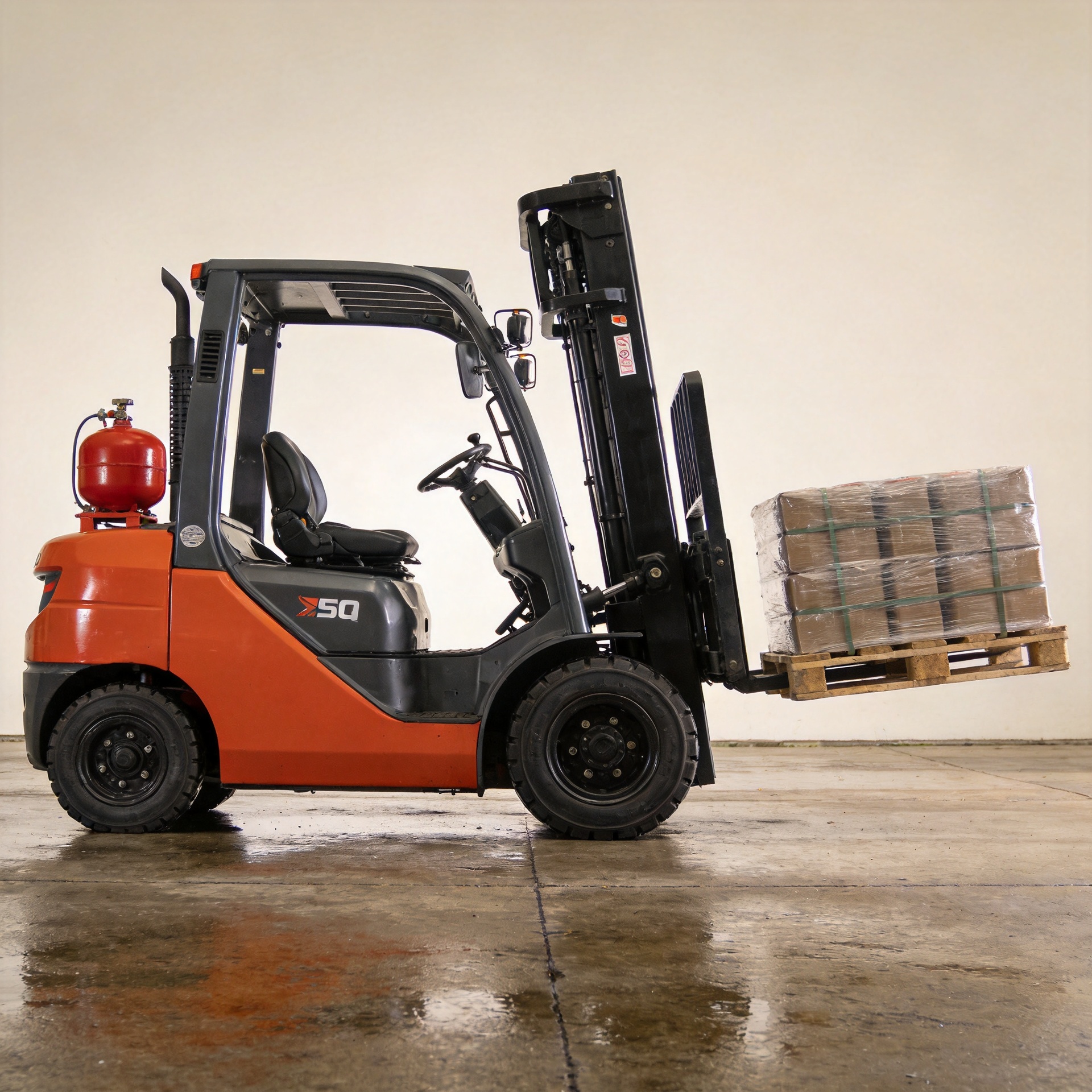 LPG counterbalance forklift maintaining stable load on wet industrial yard surface