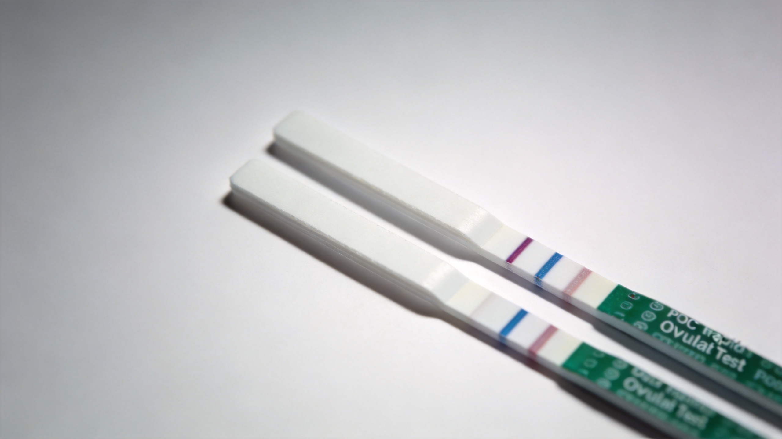 Ovulation test kit strip showing positive LH hormone detection result with test line and control line visible