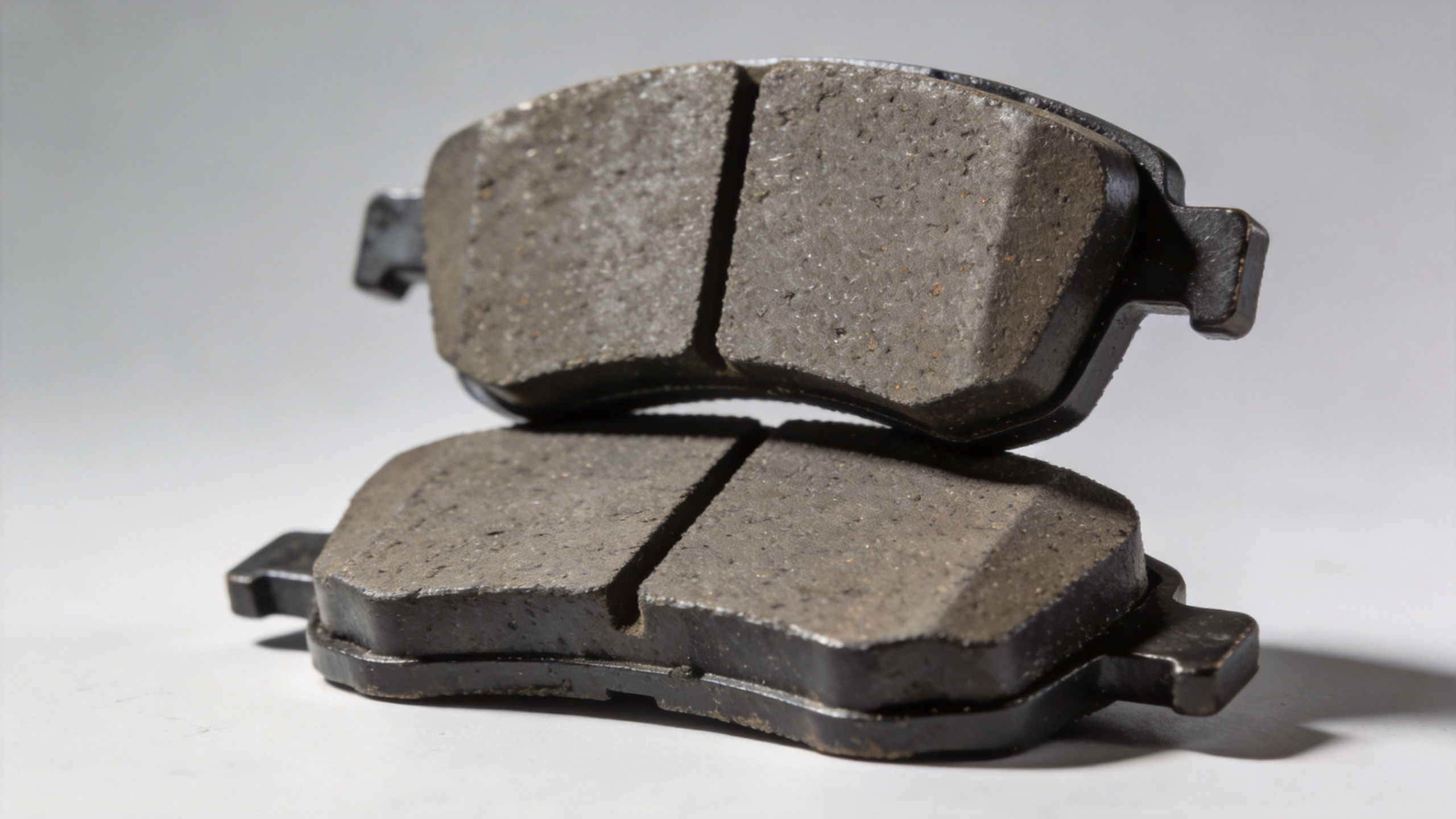 Ceramic disc brake pads shown for physical profile comparison