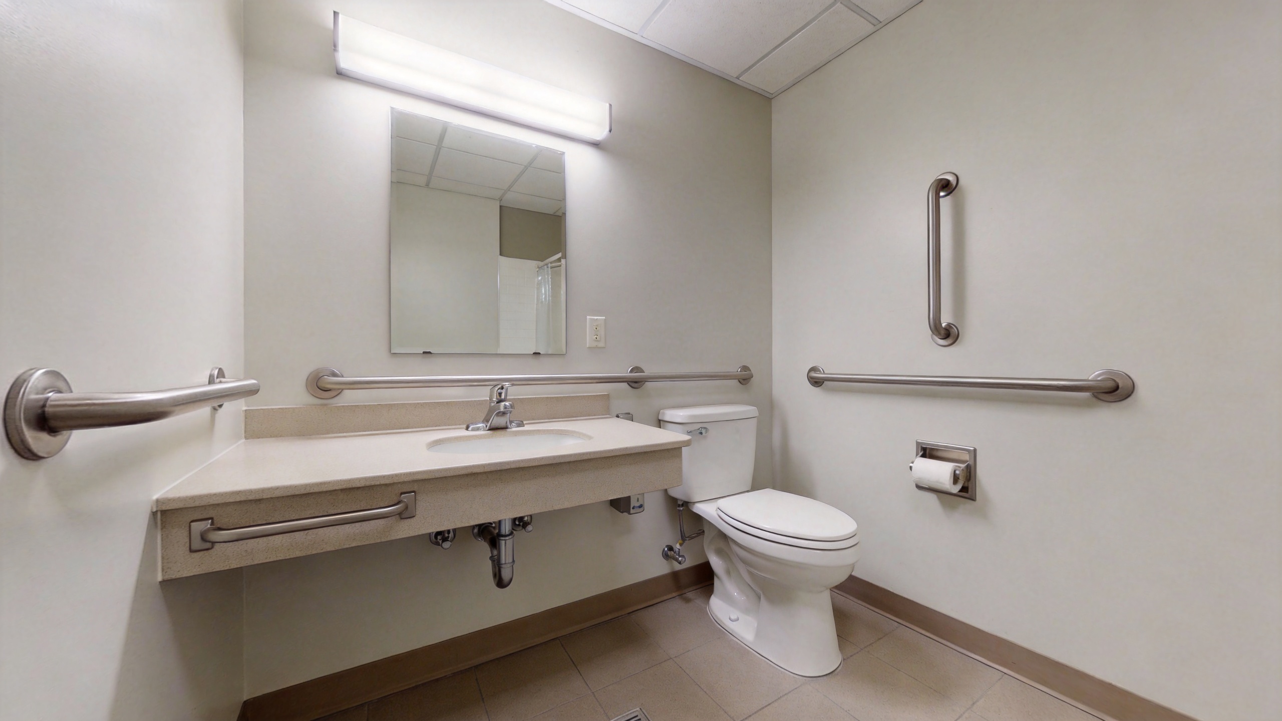 ADA-compliant accessible bathroom layout for senior living facility showing required clearance space and grab bar configuration