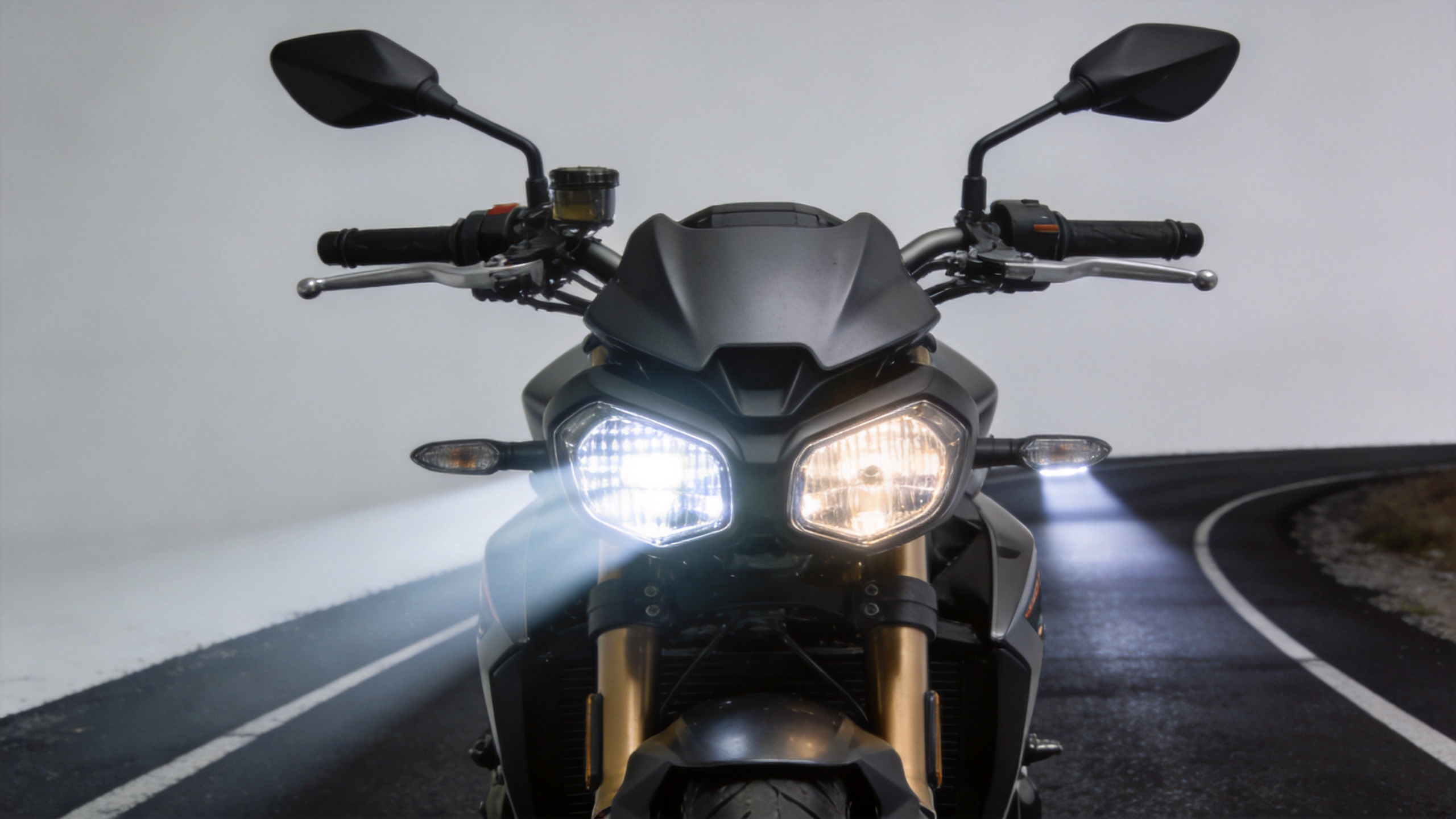 Motorcycle driving lamps illustrating forward beam control and front-end fitment
