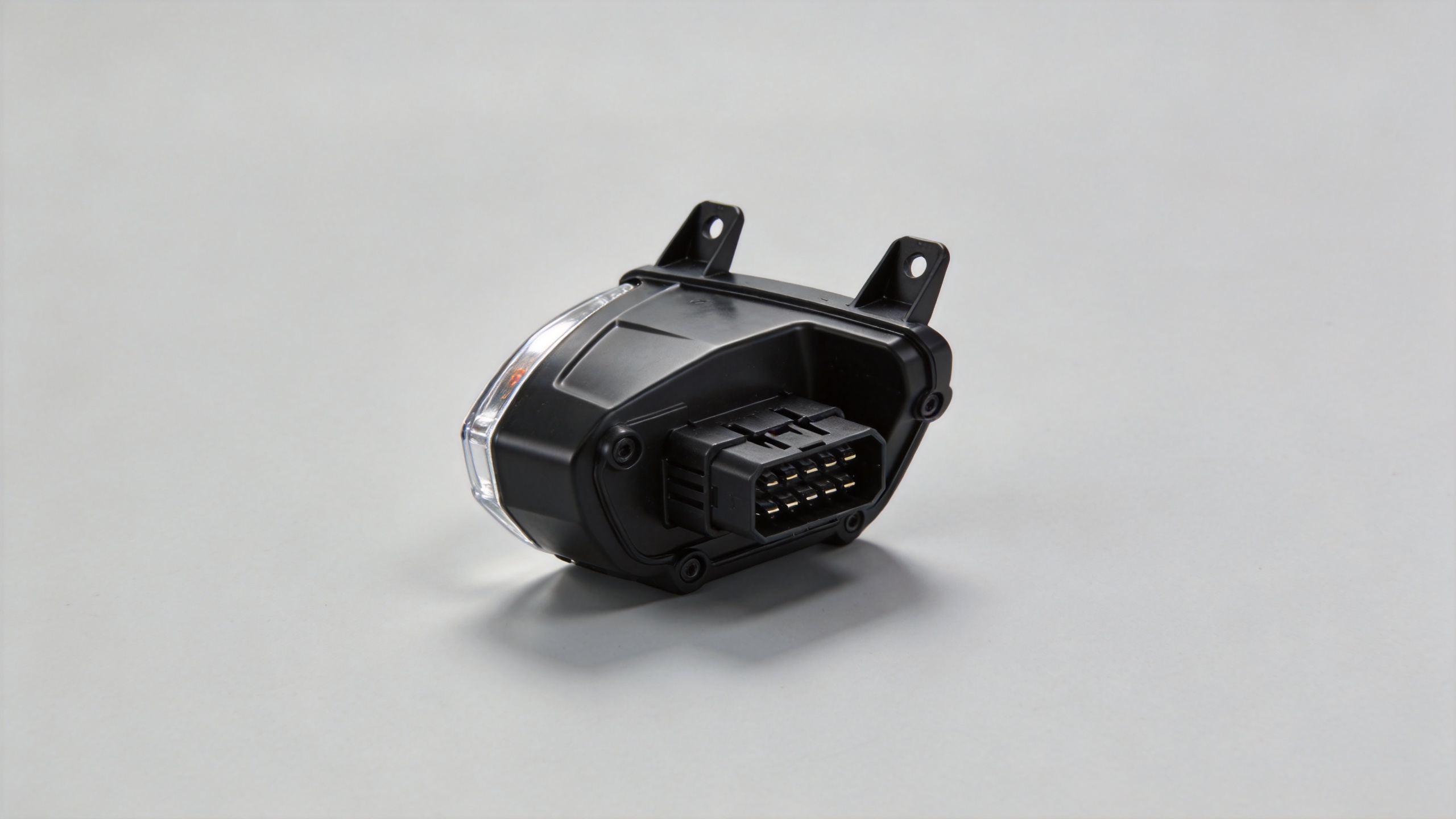 Motorbike front light housing with mounting tabs and multi-pin connector
