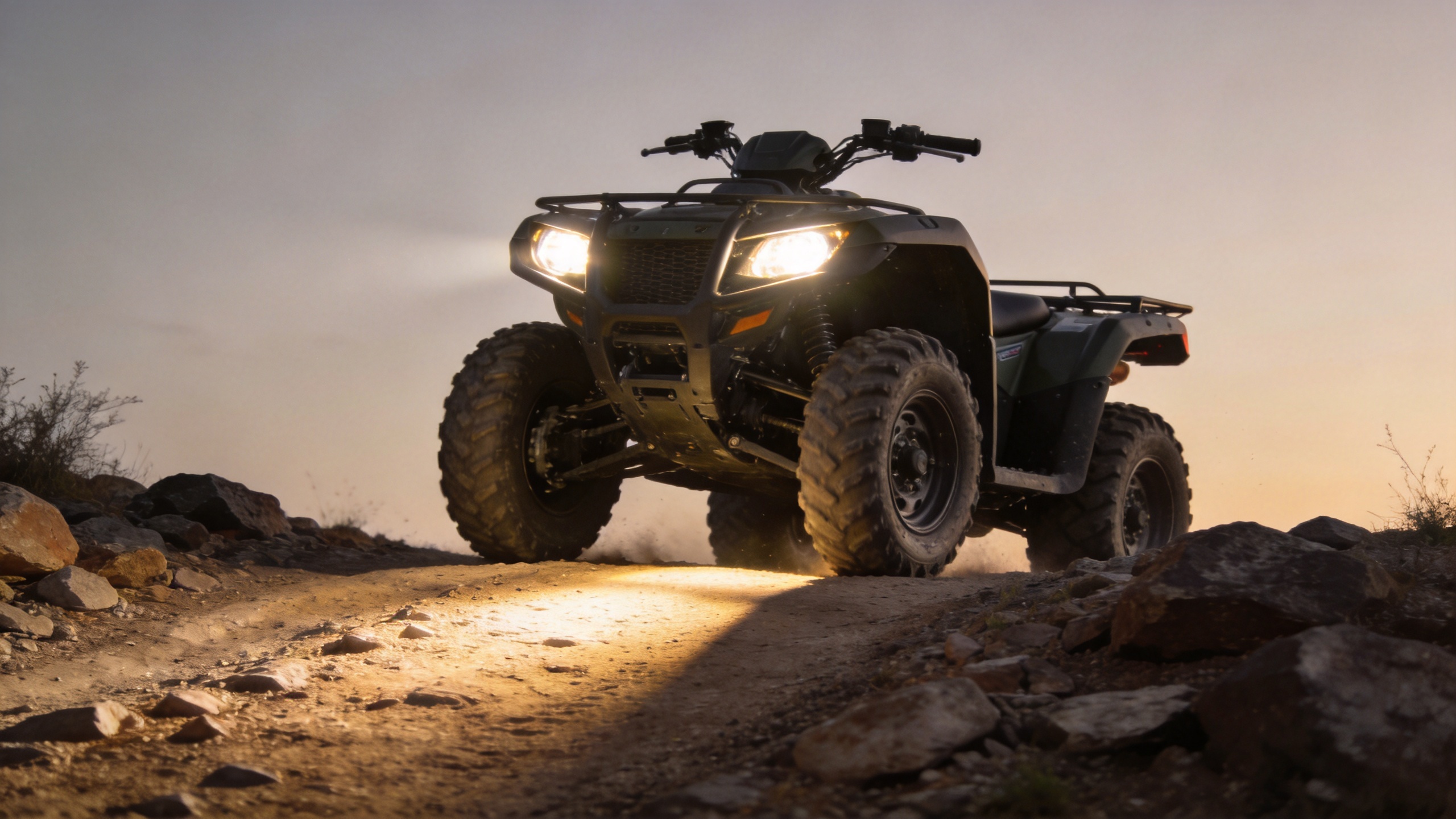 Motorcycle aux lights helping an ATV illuminate a rocky off-road trail